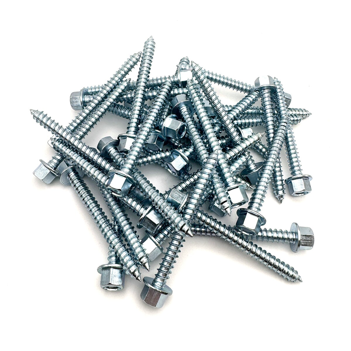 Overhead perspective of multiple 3-inch zinc lag screws with a 7/16&#39;&#39; hex head, arrayed neatly